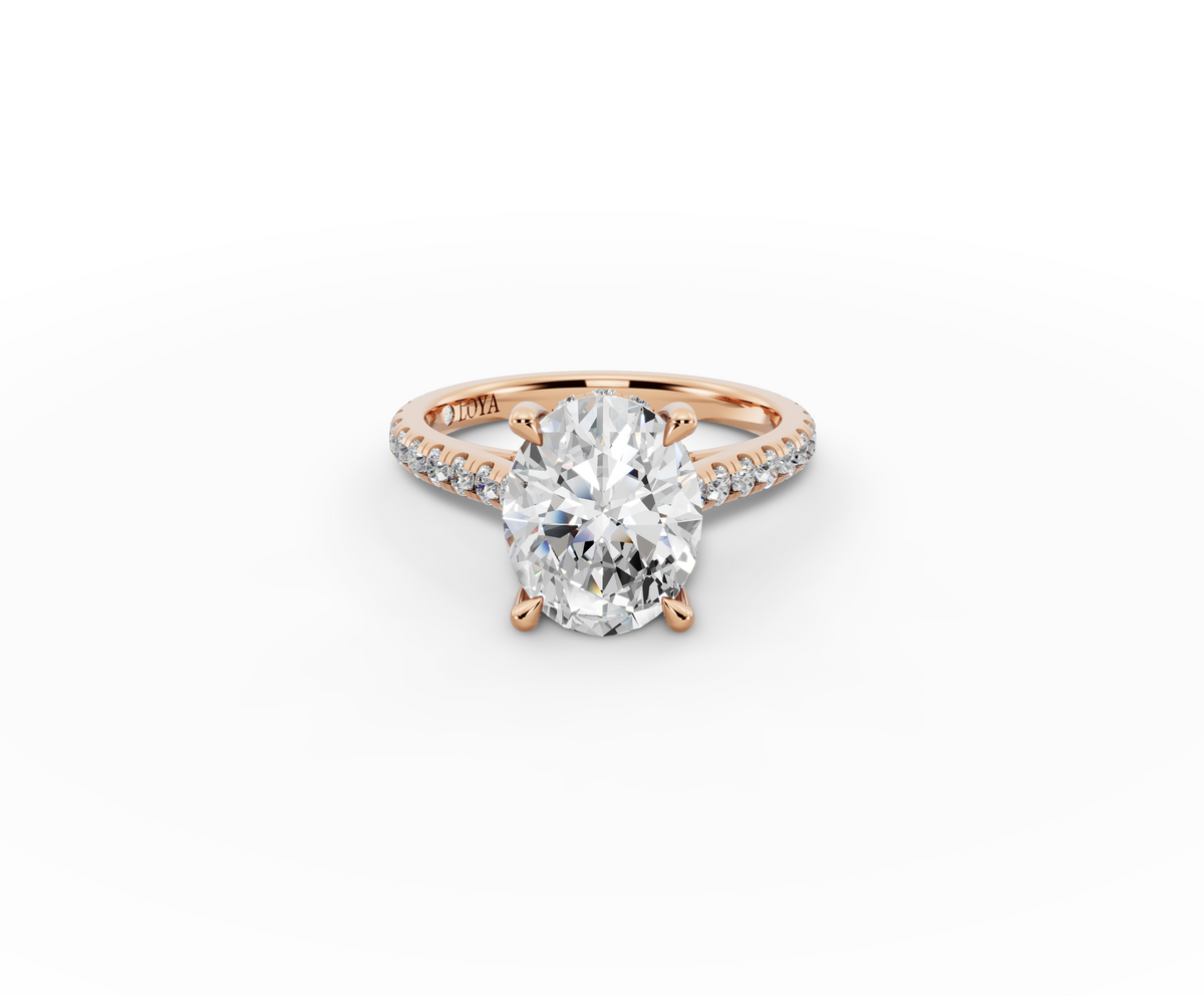 Alba Oval Shape Ring in 18K rose gold with diamonds on the band, set with a LOYA diamond (lying view)