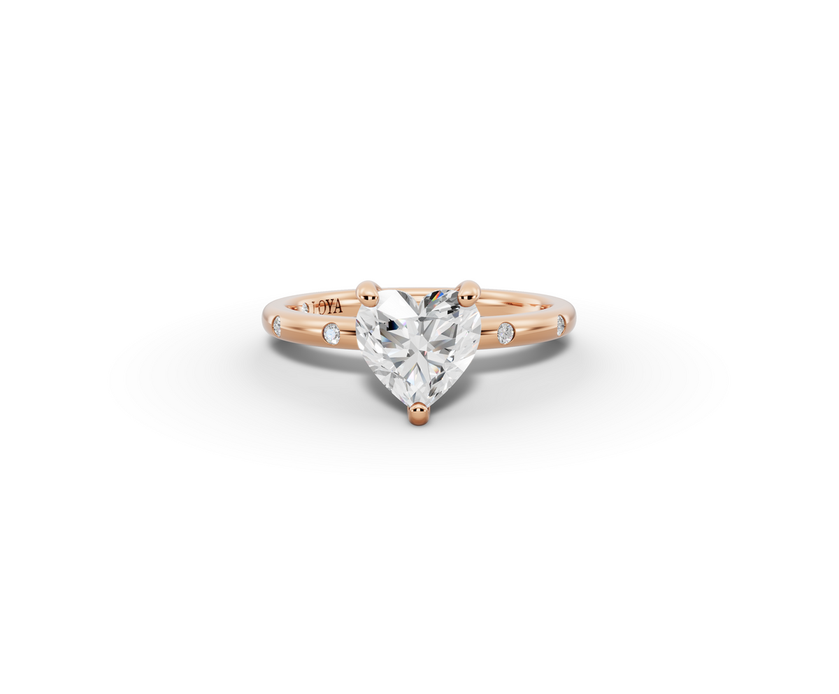 Amor Heart Shape Ring in 18K rose gold with diamonds on the band, set with a LOYA diamond (lying view)