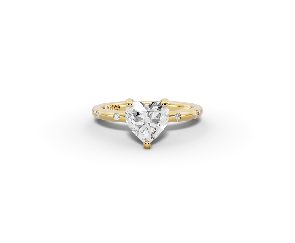 Amor Heart Shape Ring in 18K yellow gold with diamonds on the band, set with a LOYA diamond (lying view)