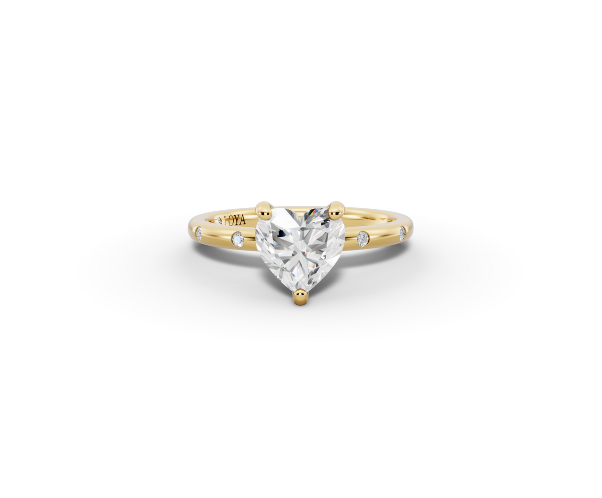 Amor Heart Shape Ring in 18K yellow gold with diamonds on the band, set with a LOYA diamond (lying view)