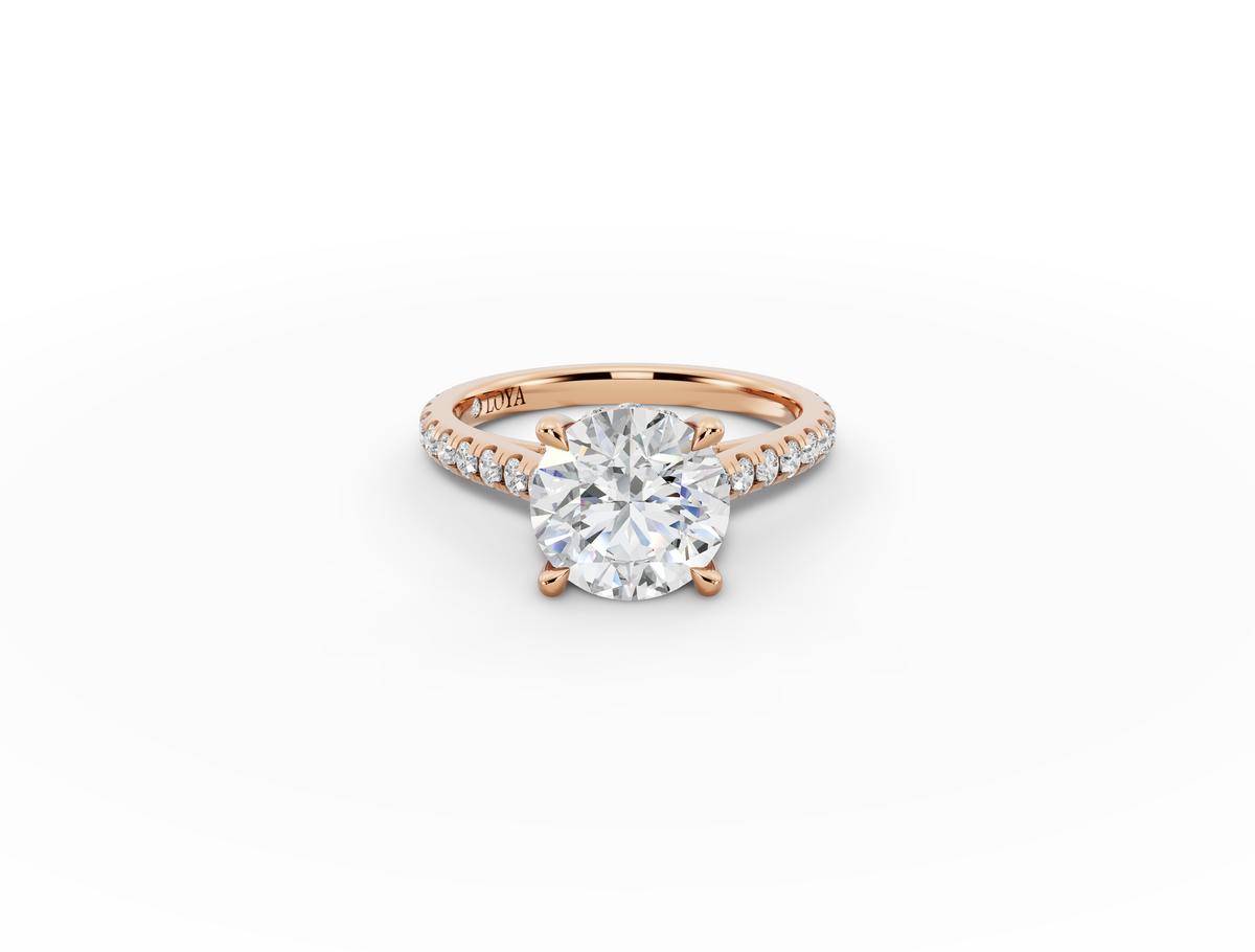 Alba Round Shape Ring in 18K rose gold with diamonds on the band, set with a LOYA diamond (lying view)