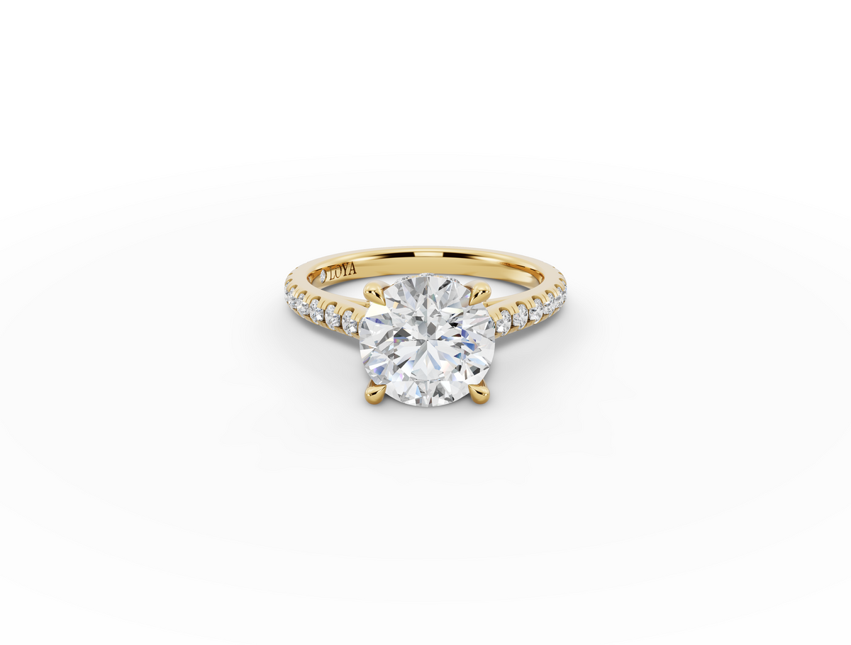 Alba Round Shape Ring in 18K yellow gold with diamonds on the band, set with a LOYA diamond (lying view)