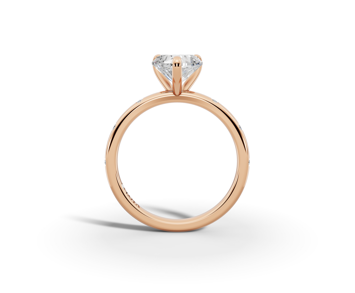 Amor Heart Shape Ring in 18K rose gold with diamonds on the band, set with a LOYA diamond (side view)