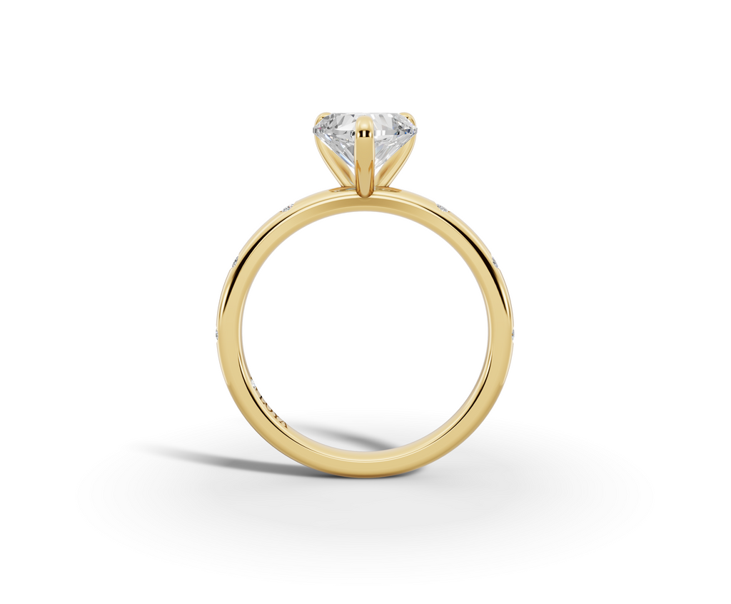 Amor Heart Shape Ring in 18K yellow gold with diamonds on the band, set with a LOYA diamond (side view)