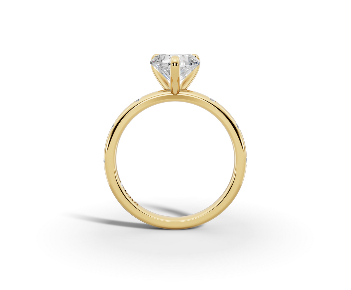Amor Heart Shape Ring in 18K yellow gold with diamonds on the band, set with a LOYA diamond (side view)